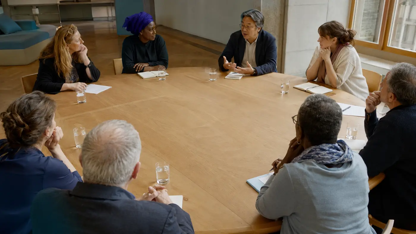 A diverse group participating in a structured round-table dialogue